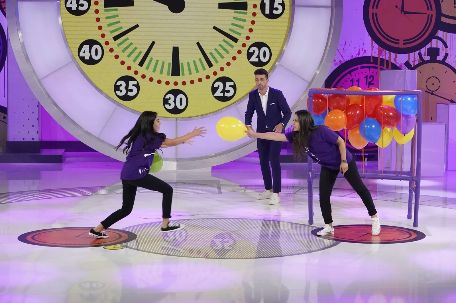 Beat the Clock production set with contestants playing a balloon challenge beneath the game clock