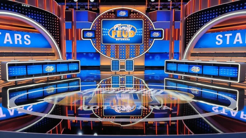 Family Feud Botswana production set with gameboard, podiums, and stage
