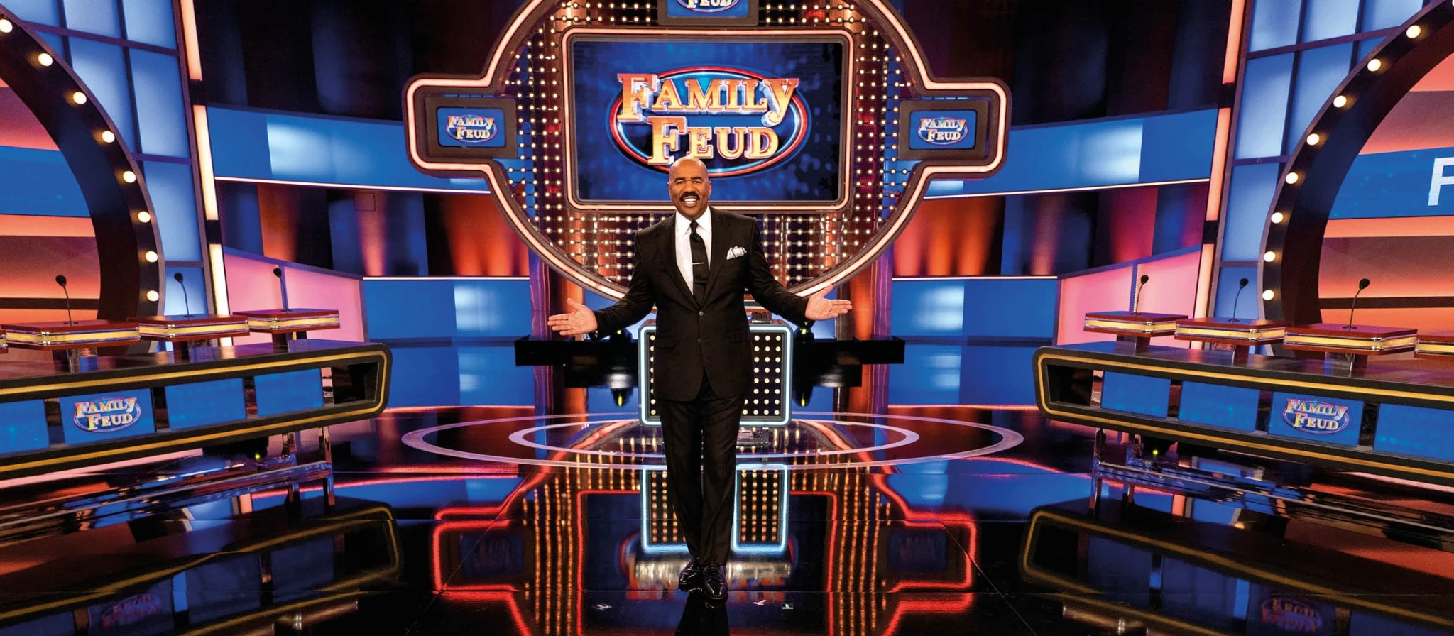 Family Feud syndicated production set with host, gameboard, and family podiums