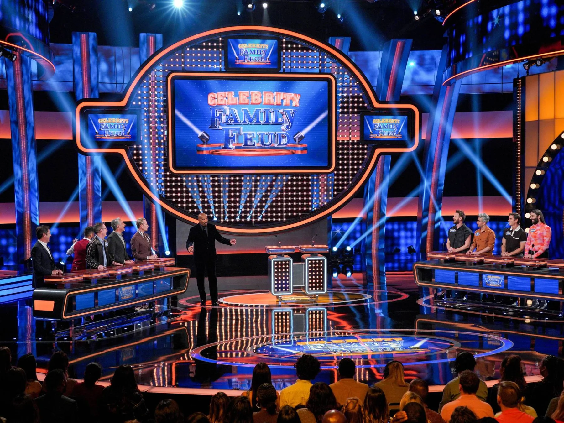 Celebrity Family Feud production set with host, contestants, gameboard, podiums, and audience