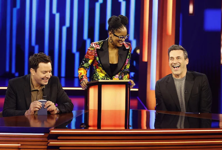 Password production set with host and celebrity panelists at the desk