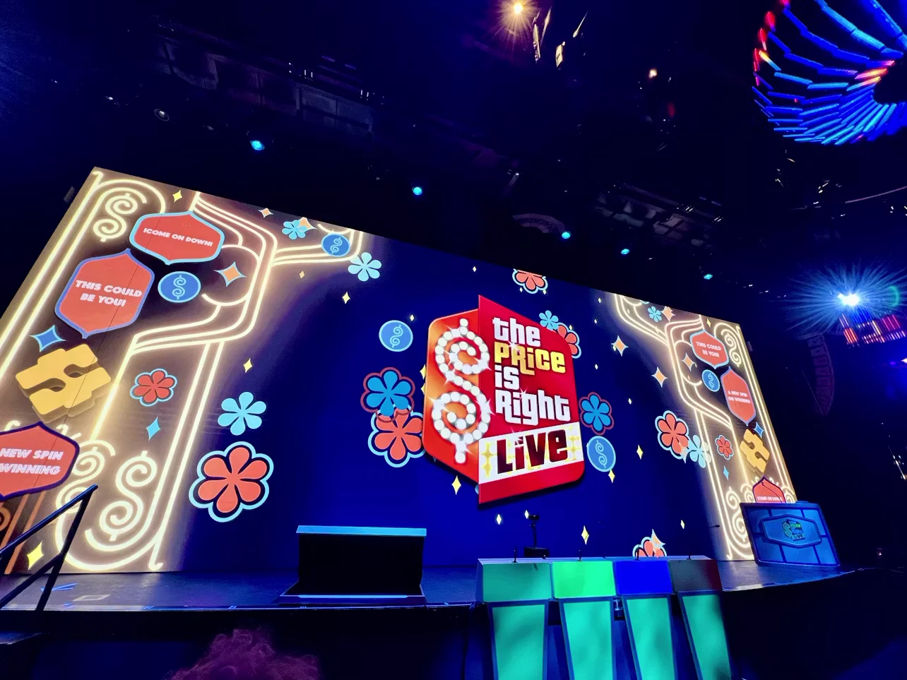 The Price Is Right LIVE stage aboard Norwegian Cruise Line with a large video wall and contestant positions